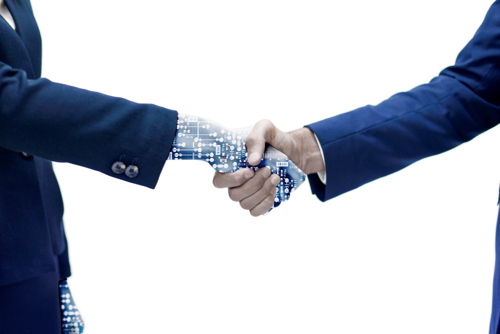 man-shaking-hand-with-robotic-arm.jpg